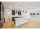 Bright kitchen featuring an island with sink, modern stainless appliances, and wood floors at 3301 Oakfields Rd # 2, New Hill, NC 27562