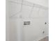 New laundry room with connections, white walls, and practical wire shelving above at 3301 Oakfields Rd # 2, New Hill, NC 27562
