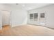 Bright living room with light wood floors, white walls, large window and door to backyard at 3301 Oakfields Rd # 2, New Hill, NC 27562