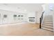 Spacious living room with wood floors, fireplace, stairs, and natural light at 3301 Oakfields Rd # 2, New Hill, NC 27562