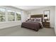 Spacious bedroom with wood-like headboard and large windows at 4043 Elk Creek Ln # 15, Raleigh, NC 27612