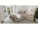 Main bedroom with a tufted headboard, neutral tones, and access to a private balcony at 4043 Elk Creek Ln # 15, Raleigh, NC 27612
