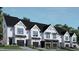 Modern townhome community with sleek, white exteriors and black garage doors at 4043 Elk Creek Ln # 15, Raleigh, NC 27612