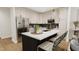 Modern kitchen with white cabinets, a large island, and stainless steel appliances at 4043 Elk Creek Ln # 15, Raleigh, NC 27612