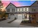 Attractive townhome displaying its front facade during sunset, showcasing architectural details and curb appeal at 507 Excelsior Ct, Rolesville, NC 27587