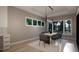 Light-filled dining room with modern chandelier, table seating, and views of outdoor scenery through large windows at 60 Chestnut Oak Dr, Youngsville, NC 27596