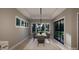 Elegant dining room with modern lighting fixture, large table, views of the backyard, and plenty of natural light at 60 Chestnut Oak Dr, Youngsville, NC 27596
