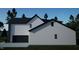 Home exterior featuring gray siding, a black roof and trim, plus an attached, two car garage at 60 Chestnut Oak Dr, Youngsville, NC 27596