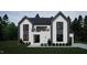 Modern two-story home with black trimmed windows, white brick and siding, a balcony, and dark gray roof at 60 Chestnut Oak Dr, Youngsville, NC 27596