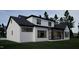 This is a modern two-story home with white siding and black trim, and a spacious backyard and patio at 60 Chestnut Oak Dr, Youngsville, NC 27596