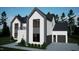 Modern two-story home with a black roof, dark gray siding, white accents, and an attached two-car garage at 60 Chestnut Oak Dr, Youngsville, NC 27596