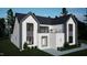 Contemporary home with dark framed windows, a second story balcony, white brick facade, and gray siding at 60 Chestnut Oak Dr, Youngsville, NC 27596