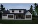 A modern home with white siding and black trim, and a covered patio with comfortable outdoor seating at 60 Chestnut Oak Dr, Youngsville, NC 27596