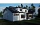 Rear exterior showing white siding, a black roof, and a sunroom with an outdoor living space at 60 Chestnut Oak Dr, Youngsville, NC 27596