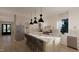 Modern kitchen with marble counters, island seating, stainless steel appliances, and pendant lighting at 60 Chestnut Oak Dr, Youngsville, NC 27596