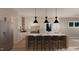 Bright kitchen featuring large island, seating, stainless steel fridge, modern fixtures, and recessed lighting at 60 Chestnut Oak Dr, Youngsville, NC 27596
