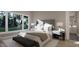 Cozy main bedroom with large windows, a king bed, ensuite bathroom, and neutral decor at 60 Chestnut Oak Dr, Youngsville, NC 27596