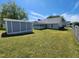 Large backyard featuring a sunroom on the house and a storage shed at 113 S Friars Chase Ln, Fuquay Varina, NC 27526