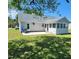 The backyard features a sunroom, back patio, and green lawn at 113 S Friars Chase Ln, Fuquay Varina, NC 27526