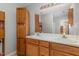 Well-lit bathroom with double sinks, built-in storage, and a large mirror at 113 S Friars Chase Ln, Fuquay Varina, NC 27526