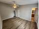 Cozy bedroom with hardwood floors, ceiling fan, and access to the bathroom at 113 S Friars Chase Ln, Fuquay Varina, NC 27526