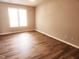 Bright, spacious bedroom with wood floors and natural light from two windows at 113 S Friars Chase Ln, Fuquay Varina, NC 27526
