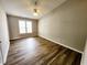Bedroom featuring a ceiling fan and large window providing natural light at 113 S Friars Chase Ln, Fuquay Varina, NC 27526