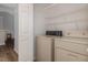 Functional laundry area featuring washer, dryer, and wire shelving for efficient storage solutions at 113 S Friars Chase Ln, Fuquay Varina, NC 27526
