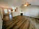 Spacious living room with hardwood floors, fireplace, and a view of the kitchen at 113 S Friars Chase Ln, Fuquay Varina, NC 27526