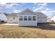 The rear exterior of the home showcases a sunroom and a small back patio at 113 S Friars Chase Ln, Fuquay Varina, NC 27526