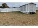Storage shed with a gray exterior and a white privacy fence at 113 S Friars Chase Ln, Fuquay Varina, NC 27526