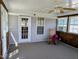 Bright sunroom featuring ceiling fan, multiple windows, and a rocking chair at 113 S Friars Chase Ln, Fuquay Varina, NC 27526