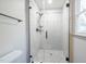 Bathroom shower featuring white subway tile, mosaic flooring, and a glass door at 2804 Edgewood Ave, Burlington, NC 27215
