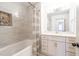 Stylish bathroom with tiled walls, bathtub, and vanity with modern fixtures at 2804 Edgewood Ave, Burlington, NC 27215