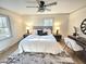 Bright bedroom featuring a ceiling fan, area rug, and desk area at 2804 Edgewood Ave, Burlington, NC 27215
