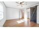 Bedroom with hardwood floors, a sliding barn door, and plenty of natural light at 2804 Edgewood Ave, Burlington, NC 27215