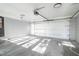 A clean, empty garage with a sealed concrete floor, a white door, and an automatic garage door opener at 2804 Edgewood Ave, Burlington, NC 27215