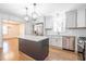 Open-concept kitchen with island, stainless appliances, and hardwood floors at 2804 Edgewood Ave, Burlington, NC 27215