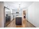 Well-lit kitchen with stainless steel appliances, island, and hardwood floors at 2804 Edgewood Ave, Burlington, NC 27215