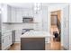 Charming kitchen with island, stainless steel appliances, and view of the staircase at 2804 Edgewood Ave, Burlington, NC 27215