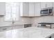 Bright kitchen featuring modern appliances, countertops, and subway tile backsplash at 2804 Edgewood Ave, Burlington, NC 27215