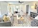 Inviting living room featuring stylish furniture, patterned rug, and a modern ceiling fan at 2804 Edgewood Ave, Burlington, NC 27215