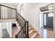 Staircase with dark railing, hardwood steps, and views of the entryway and living area at 2804 Edgewood Ave, Burlington, NC 27215