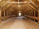 Unfinished attic space with wood flooring and window at 368 Hampshire Ct, Four Oaks, NC 27524