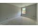 New bedroom with neutral gray walls and floors, featuring a single window at 478 Traditions Grande Blvd # 32, Wake Forest, NC 27587