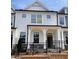 Charming two-story townhome with white siding, black trim, and a wrought iron fence at 478 Traditions Grande Blvd # 32, Wake Forest, NC 27587