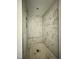 Walk-in shower featuring marbled tiling and convenient built-in bench at 478 Traditions Grande Blvd # 32, Wake Forest, NC 27587