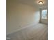 A carpeted bedroom with a window allowing for natural light to brighten the space at 482 Traditions Grande Blvd # 30, Wake Forest, NC 27587