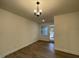 Bright dining area with hardwood floors, elegant chandelier, and backyard access at 482 Traditions Grande Blvd # 30, Wake Forest, NC 27587