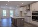 Open-concept kitchen boasts a large island, stainless appliances, and adjacent open dining space at 482 Traditions Grande Blvd # 30, Wake Forest, NC 27587